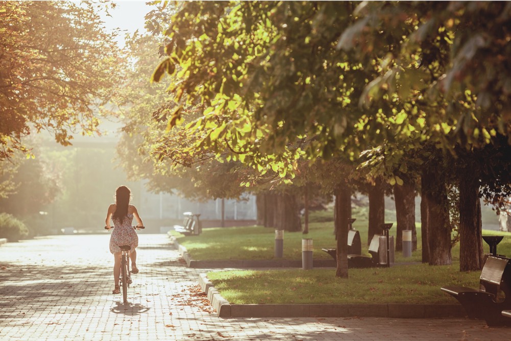 young girl with bicycle park